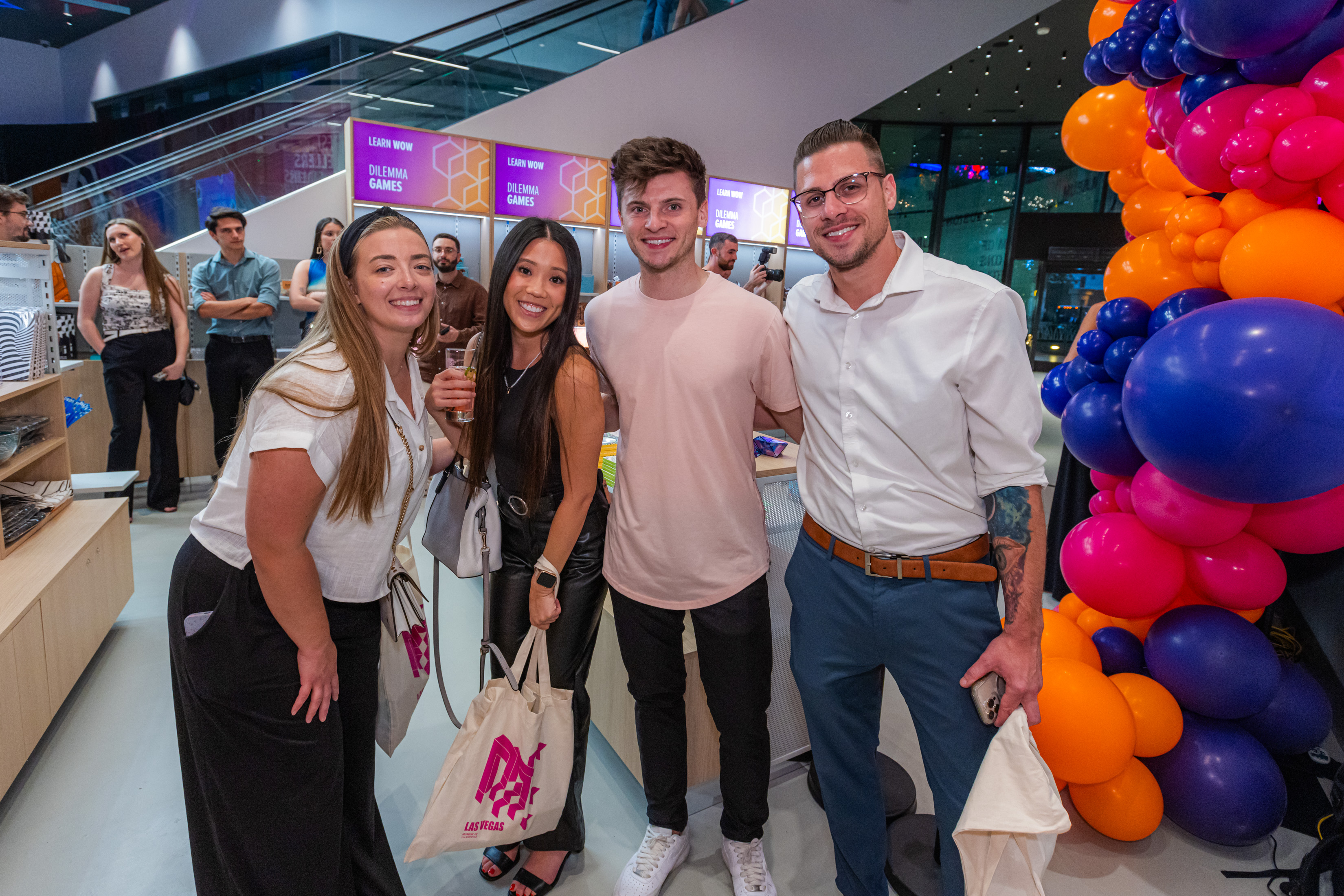 Four young persons are posing for a photo at a graduation party at Museum of Illusions Las Vegas.