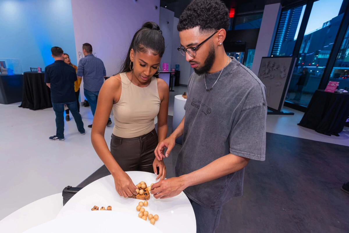 A young couple is trying to solve a brain-teasing puzzle at the event in Museum of Illusions Las Vegas.